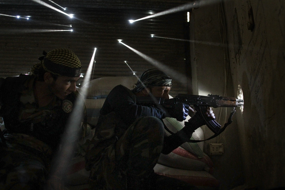 Két fellázadó szíriai katona védi a golyókkal átlyuggatott bunkerét (Fotó: Javier Manzano/AFP/Getty Images, blogs.wsj.com)
