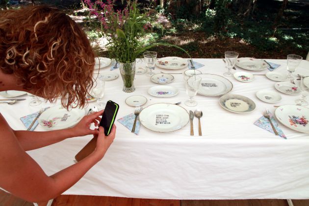 Hitka Viktória képzőművész étkészletét fotózza egy látogató (MTI Fotó: Nagy Lajos)